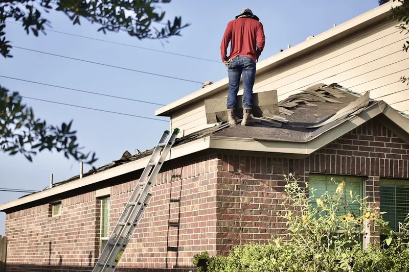 Professional roofer working on a residential roof in Parker Ford